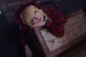 Rating: Safe Score: 0 Tags: 1girl bangs blonde_hair blue_eyes blunt_bangs bonnet dress flower head_rest lips long_hair long_sleeves looking_at_viewer red_dress red_flower red_rose rose shinku sitting solo User: admin