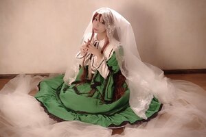 Rating: Safe Score: 0 Tags: 1girl brown_hair dress green_dress green_eyes long_hair long_sleeves sitting solo suiseiseki veil User: admin