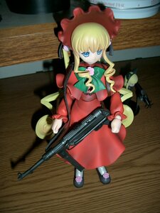 Rating: Safe Score: 0 Tags: 1girl blonde_hair blue_eyes bonnet bow doll dress gun long_hair long_sleeves looking_at_viewer photo red_dress shinku solo standing weapon User: admin