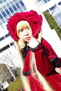 Rating: Safe Score: 0 Tags: 1girl bangs blonde_hair blue_eyes blurry blurry_background blurry_foreground bonnet building day depth_of_field dress drill_hair long_hair long_sleeves looking_at_viewer outdoors photo red_dress shinku solo User: admin