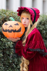 Rating: Safe Score: 0 Tags: 1girl bangs blonde_hair blue_eyes blurry blurry_background bonnet depth_of_field dress halloween hat jack-o'-lantern lips long_hair long_sleeves looking_at_viewer outdoors pumpkin red_dress shinku solo User: admin