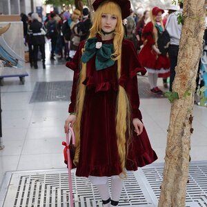 Rating: Safe Score: 0 Tags: 1girl blonde_hair blurry bow building city depth_of_field dress hat long_hair multiple_girls photo photo_background realistic shinku solo standing User: admin