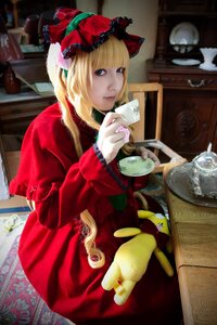 Rating: Safe Score: 0 Tags: 1girl blonde_hair blue_eyes bonnet cup dress flower red_dress saucer shinku sitting solo teacup User: admin