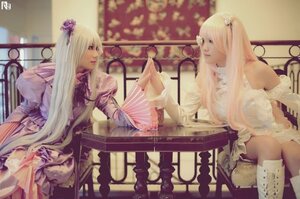 Rating: Safe Score: 0 Tags: 2girls blonde_hair chair dress flower frills hair_flower hair_ornament indoors long_hair multiple_cosplay multiple_girls sitting tagme white_dress User: admin