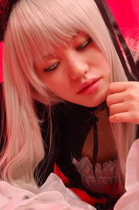 Rating: Safe Score: 0 Tags: 1girl bangs blonde_hair lips long_hair looking_at_viewer nose red_background solo suigintou yellow_eyes User: admin