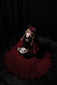 Rating: Safe Score: 0 Tags: 1girl blonde_hair blue_eyes cup dark dress long_sleeves looking_at_viewer red_dress shinku sitting solo teacup User: admin