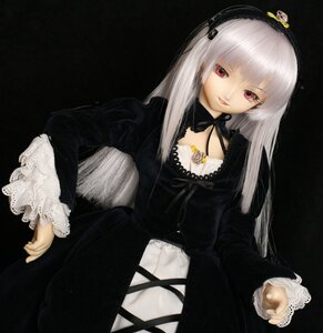 Rating: Safe Score: 0 Tags: 1girl bangs black_background detached_collar doll dress frills hairband long_hair long_sleeves looking_at_viewer red_eyes ribbon silver_hair simple_background sitting solo suigintou User: admin