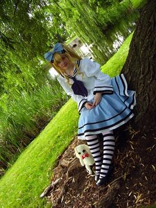 Rating: Safe Score: 0 Tags: 1girl blonde_hair bow dress grass hair_bow long_hair realistic shinku sitting solo striped striped_legwear tree User: admin
