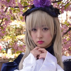 Rating: Safe Score: 0 Tags: 1girl bangs blonde_hair blurry blurry_background blurry_foreground depth_of_field flower hair_flower lips long_hair long_sleeves looking_at_viewer outdoors purple_flower realistic sleeves_past_wrists solo suigintou upper_body wisteria User: admin