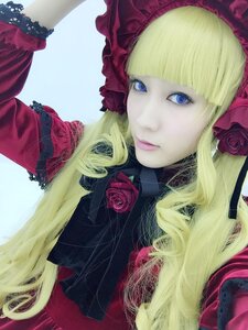 Rating: Safe Score: 0 Tags: 1girl bangs blonde_hair blue_background blue_eyes bonnet dress drill_hair eyelashes flower lips long_hair looking_at_viewer pink_flower pink_rose red_flower red_rose rose shinku solo User: admin