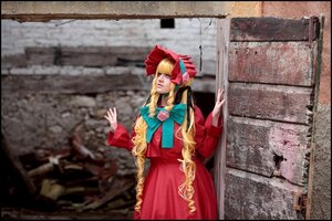 Rating: Safe Score: 0 Tags: 1girl black_border blonde_hair blurry bonnet border bow depth_of_field dress drill_hair flower letterboxed long_hair long_sleeves red_dress shinku solo standing User: admin