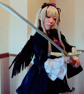 Rating: Safe Score: 0 Tags: 1girl black_dress blonde_hair blurry closed_mouth dress holding long_hair long_sleeves ribbon solo standing suigintou sword weapon User: admin