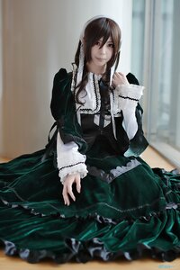 Rating: Safe Score: 0 Tags: 1girl black_dress blurry blurry_background brown_hair depth_of_field dress frills indoors jewelry long_hair long_sleeves looking_at_viewer necklace sitting solo suiseiseki User: admin