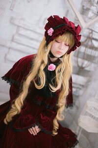 Rating: Safe Score: 0 Tags: 1girl blonde_hair blurry blurry_background bonnet bow capelet closed_eyes depth_of_field dress facing_viewer flower lolita_fashion long_hair long_sleeves red_dress rose shinku solo User: admin
