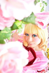 Rating: Safe Score: 0 Tags: 1girl bangs blonde_hair blue_eyes blunt_bangs blurry blurry_background blurry_foreground depth_of_field dress flower hinaichigo lips looking_at_viewer lying motion_blur photo pink_dress plant solo User: admin