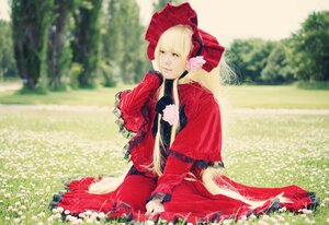 Rating: Safe Score: 0 Tags: 1girl blonde_hair blue_eyes blurry bonnet bow dress field flower frills garden grass long_hair long_sleeves outdoors red_dress shinku sitting solo User: admin