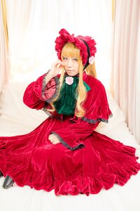 Rating: Safe Score: 0 Tags: 1girl bangs blonde_hair blue_eyes bonnet bow curtains dress flower frills green_neckwear long_hair long_sleeves looking_at_viewer red_dress rose shinku sitting solo User: admin