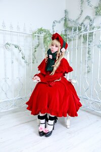 Rating: Safe Score: 0 Tags: 1girl blonde_hair blue_eyes bonnet doll_joints dress flower long_hair long_sleeves red_capelet red_dress shinku sitting solo User: admin