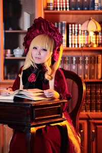 Rating: Safe Score: 0 Tags: 1girl blonde_hair blue_eyes blurry blurry_background bonnet book bookshelf depth_of_field dress flower library long_hair red_dress rose shinku sitting solo User: admin