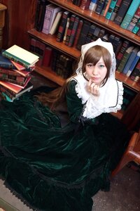 Rating: Safe Score: 0 Tags: 1girl book book_stack bookshelf brown_hair dress green_dress green_eyes heterochromia library long_hair red_eyes sitting solo suiseiseki User: admin
