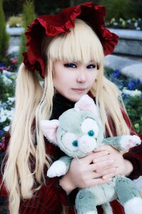 Rating: Safe Score: 0 Tags: 1girl animal bangs blonde_hair blue_eyes blurry blurry_background bonnet closed_mouth depth_of_field holding_animal long_hair long_sleeves outdoors red_dress shinku smile solo upper_body User: admin
