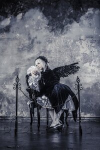Rating: Safe Score: 0 Tags: 1girl black_wings boots dress feathered_wings gothic_lolita hairband long_hair long_sleeves looking_at_viewer monochrome sitting solo standing suigintou wings User: admin
