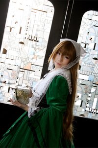 Rating: Safe Score: 0 Tags: 1girl auto_tagged brown_hair building city dress green_dress hood long_hair looking_at_viewer smile solo suiseiseki User: admin