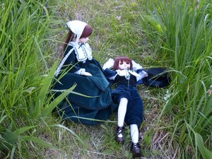Rating: Safe Score: 0 Tags: 1boy 1girl apron blue_dress brown_hair doll dress grass long_sleeves multiple_dolls outdoors short_hair shorts sitting tagme User: admin
