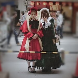 Rating: Safe Score: 0 Tags: 1girl animal_ears blurry blurry_background blurry_foreground depth_of_field dress long_hair motion_blur multiple_cosplay photo standing tagme User: admin
