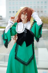 Rating: Safe Score: 0 Tags: 1girl artist_name auto_tagged bangs blurry building depth_of_field dress frills green_dress long_hair long_sleeves looking_at_viewer solo standing suiseiseki User: admin