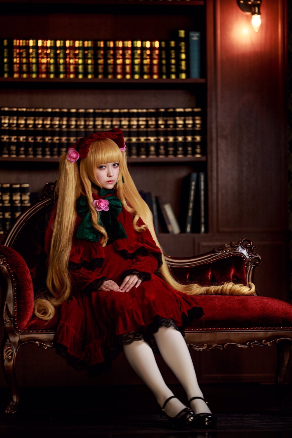 1girl blonde_hair blue_eyes bookshelf bow chair dress flower lips lolita_fashion long_hair looking_at_viewer red_dress rose shinku sitting solo twintails very_long_hair
