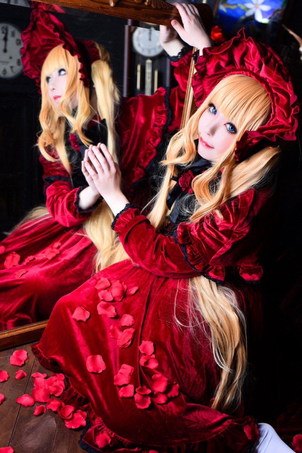 1girl 2girls blonde_hair blue_eyes blurry bonnet bow curtains depth_of_field dress flower indoors long_hair multiple_girls red_dress rose shinku sitting solo
