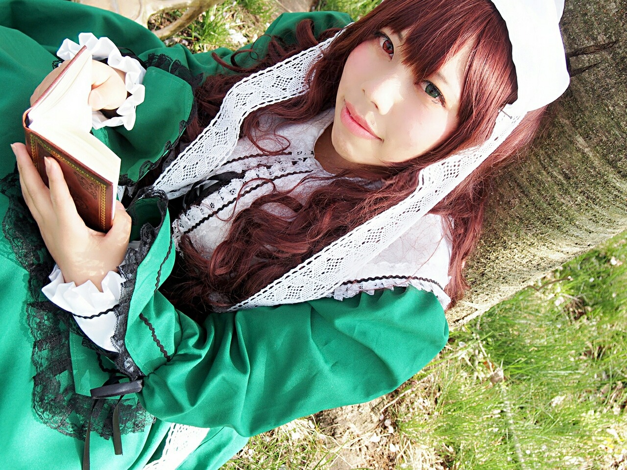 1girl book brown_hair dress green_dress heterochromia holding lips long_hair long_sleeves looking_at_viewer red_eyes smile solo suiseiseki