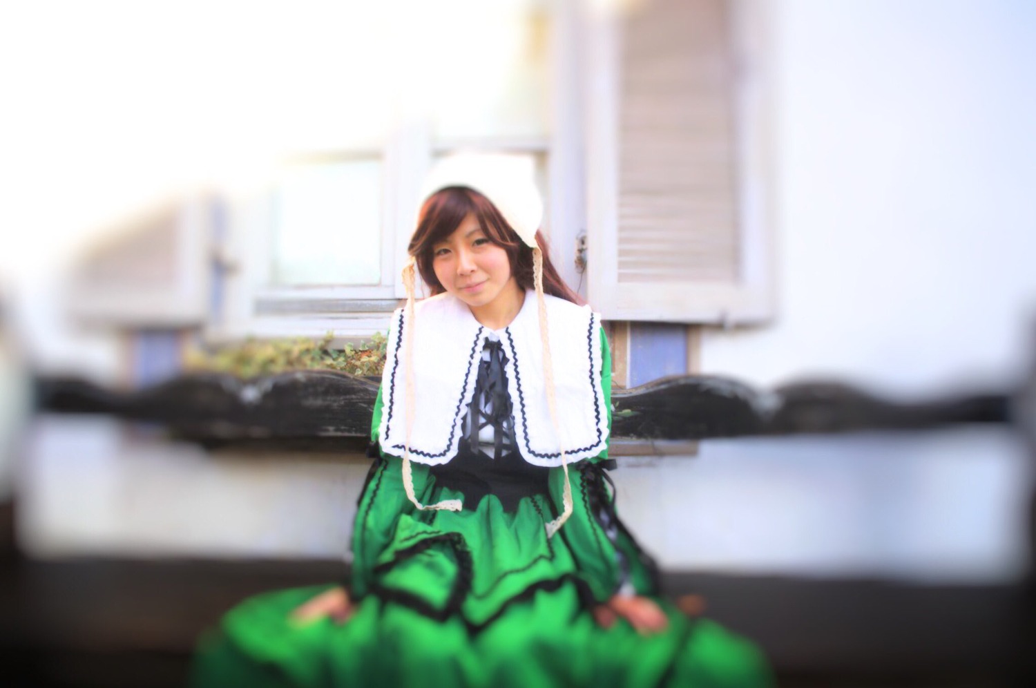 1girl blurry blurry_background blurry_foreground brown_hair depth_of_field dress motion_blur photo solo suiseiseki