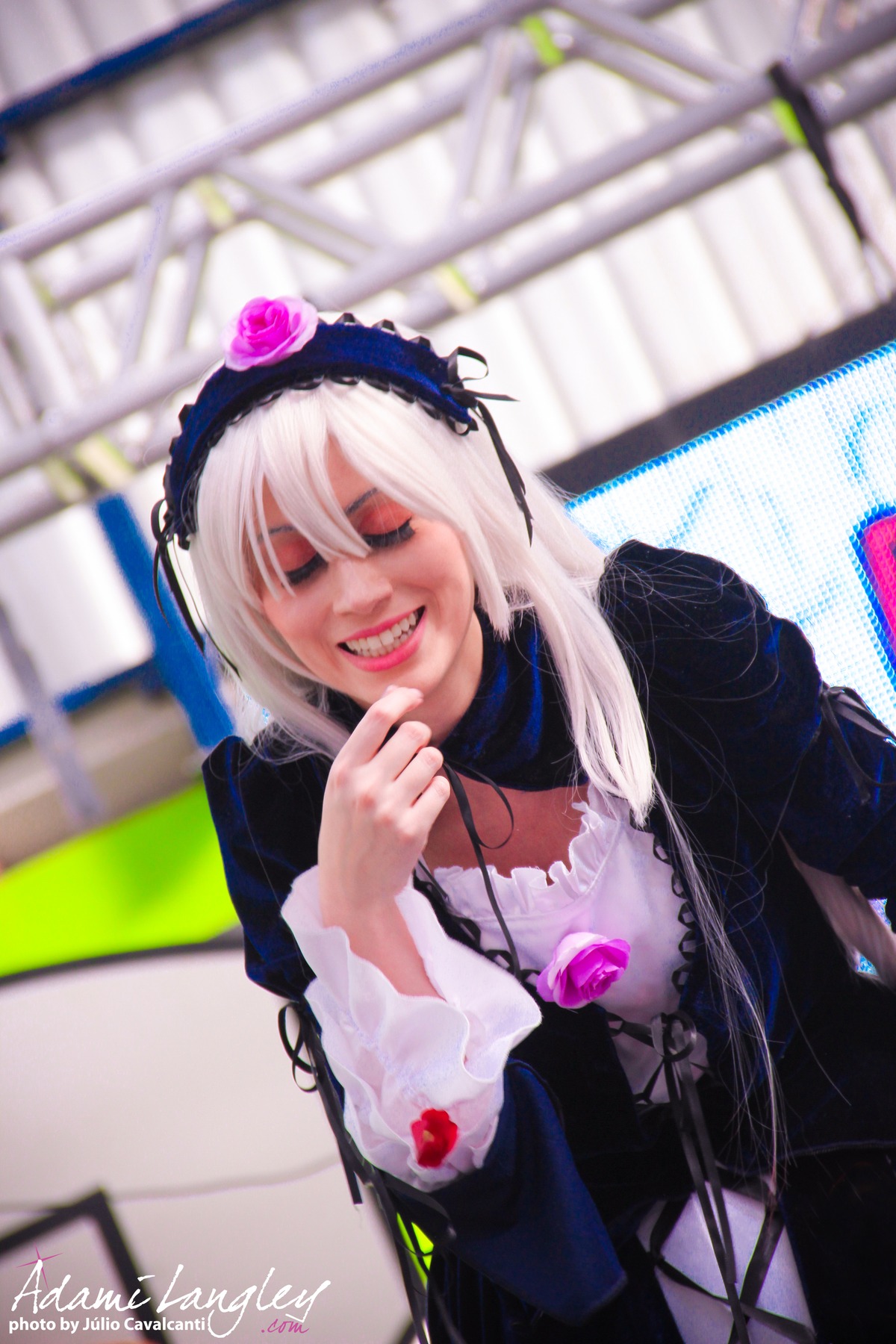 1girl black_dress blurry blurry_background blurry_foreground depth_of_field dress flower gothic_lolita hairband long_hair long_sleeves photo smile solo suigintou teeth