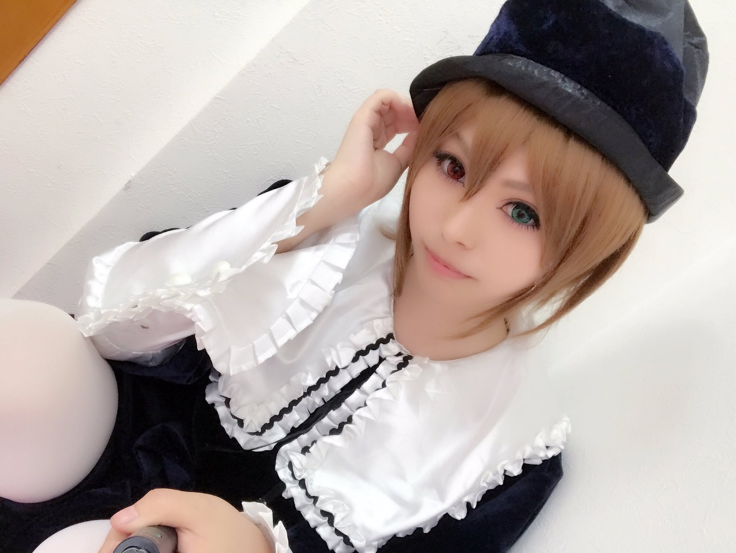 1girl blonde_hair blue_eyes dress frills hat heterochromia lips long_sleeves looking_at_viewer short_hair sitting smile solo souseiseki