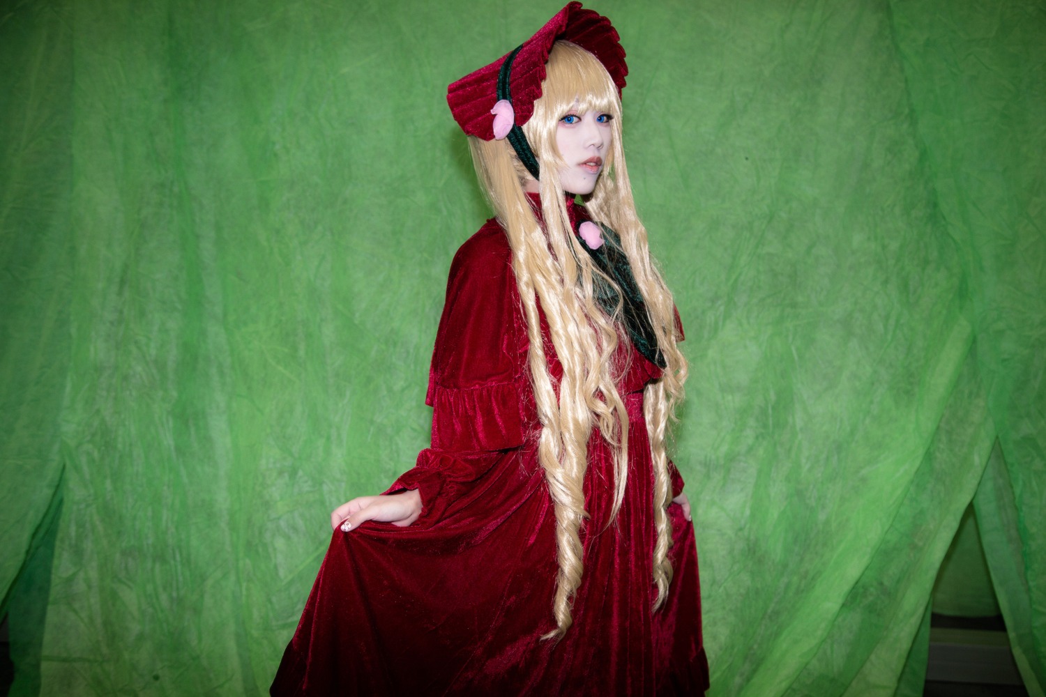 1girl blonde_hair blue_eyes bonnet dress green_background lips long_hair long_sleeves looking_at_viewer red_dress shinku solo