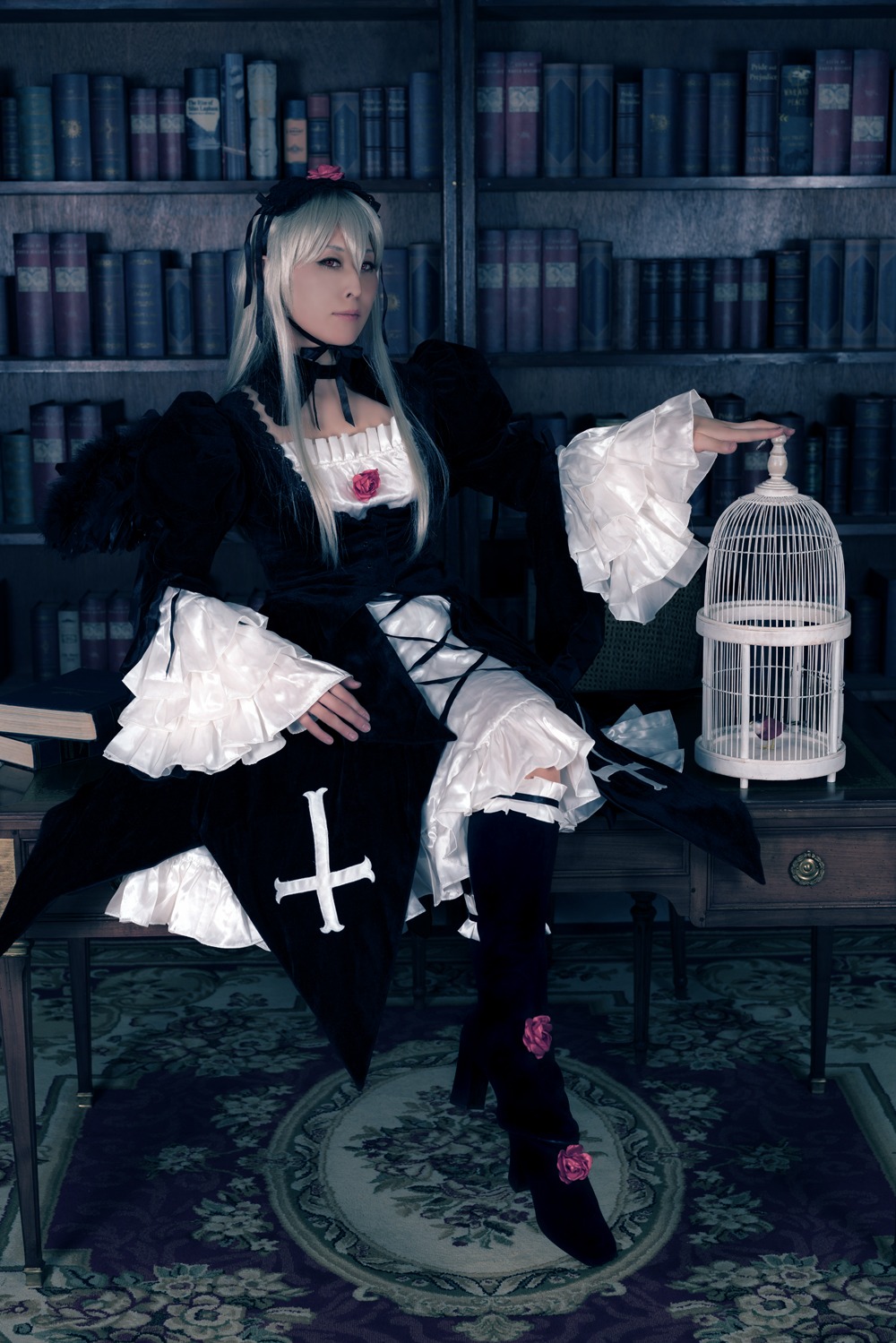 1girl book book_stack bookshelf choker dress flower gothic gothic_lolita hat library lolita_fashion long_hair long_sleeves rose sitting solo suigintou