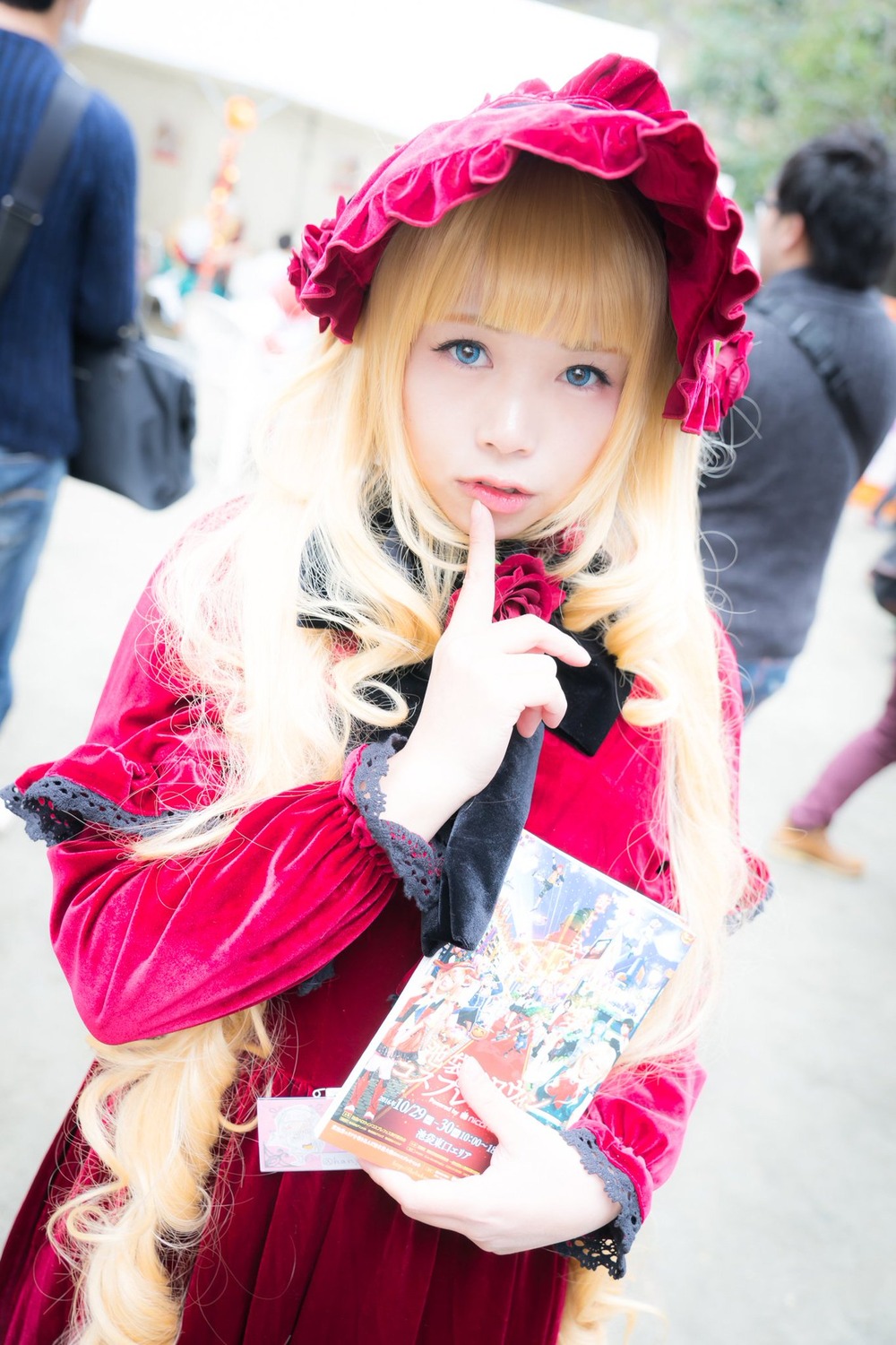 1girl bangs blonde_hair blue_eyes blurry blurry_background blurry_foreground depth_of_field dress flower frills hat lips looking_at_viewer multiple_boys photo rose shinku solo solo_focus