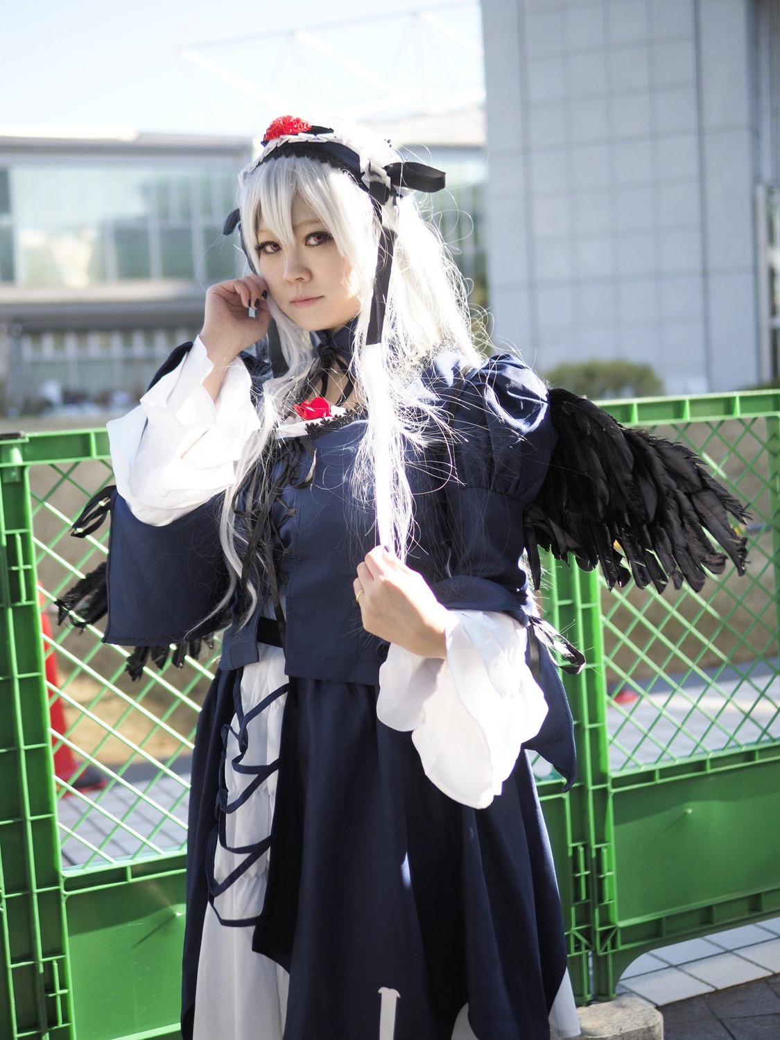 1girl black_dress blurry blurry_background chain-link_fence depth_of_field dress fence long_hair long_sleeves looking_at_viewer necklace solo stained_glass standing suigintou tile_floor tile_wall tiles white_hair