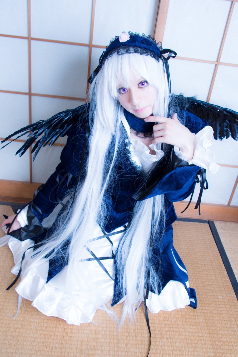 1girl black_wings dress feathered_wings feathers gothic_lolita hairband lolita_fashion long_hair long_sleeves looking_at_viewer purple_eyes seiza shouji sitting sliding_doors solo suigintou tatami white_hair wings yokozuwari
