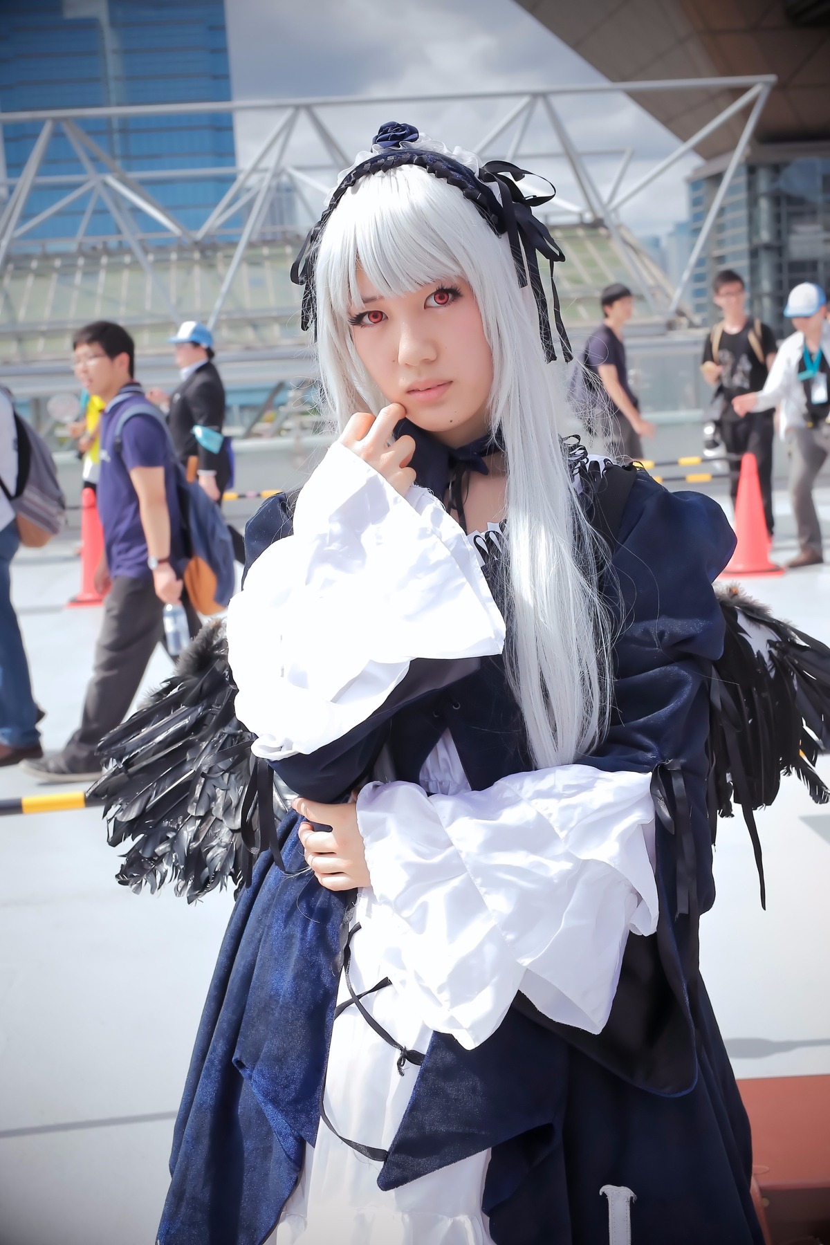 1girl 3d 6+boys blurry blurry_background depth_of_field dress hairband long_hair long_sleeves looking_at_viewer multiple_boys photo red_eyes solo solo_focus standing suigintou