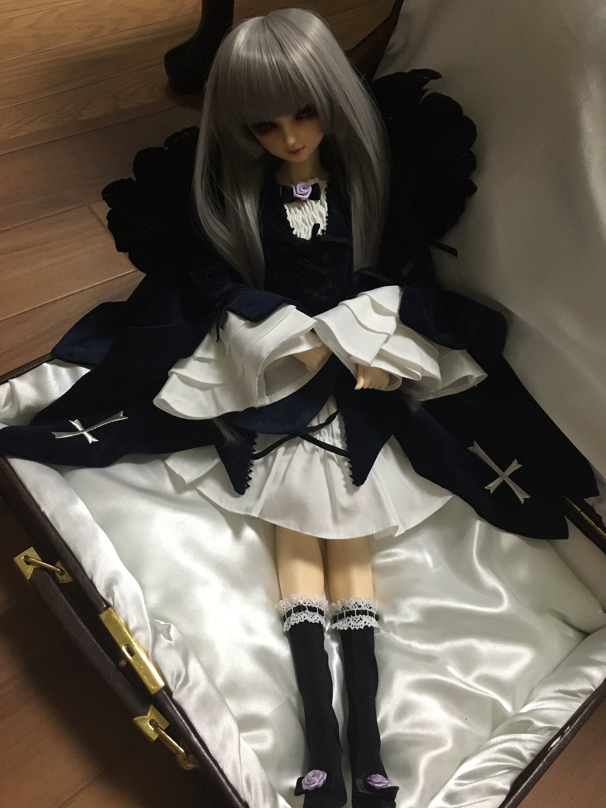 1girl bed black_legwear cross doll dress gun handgun lace long_hair lying photo solo suigintou thighhighs weapon white_hair