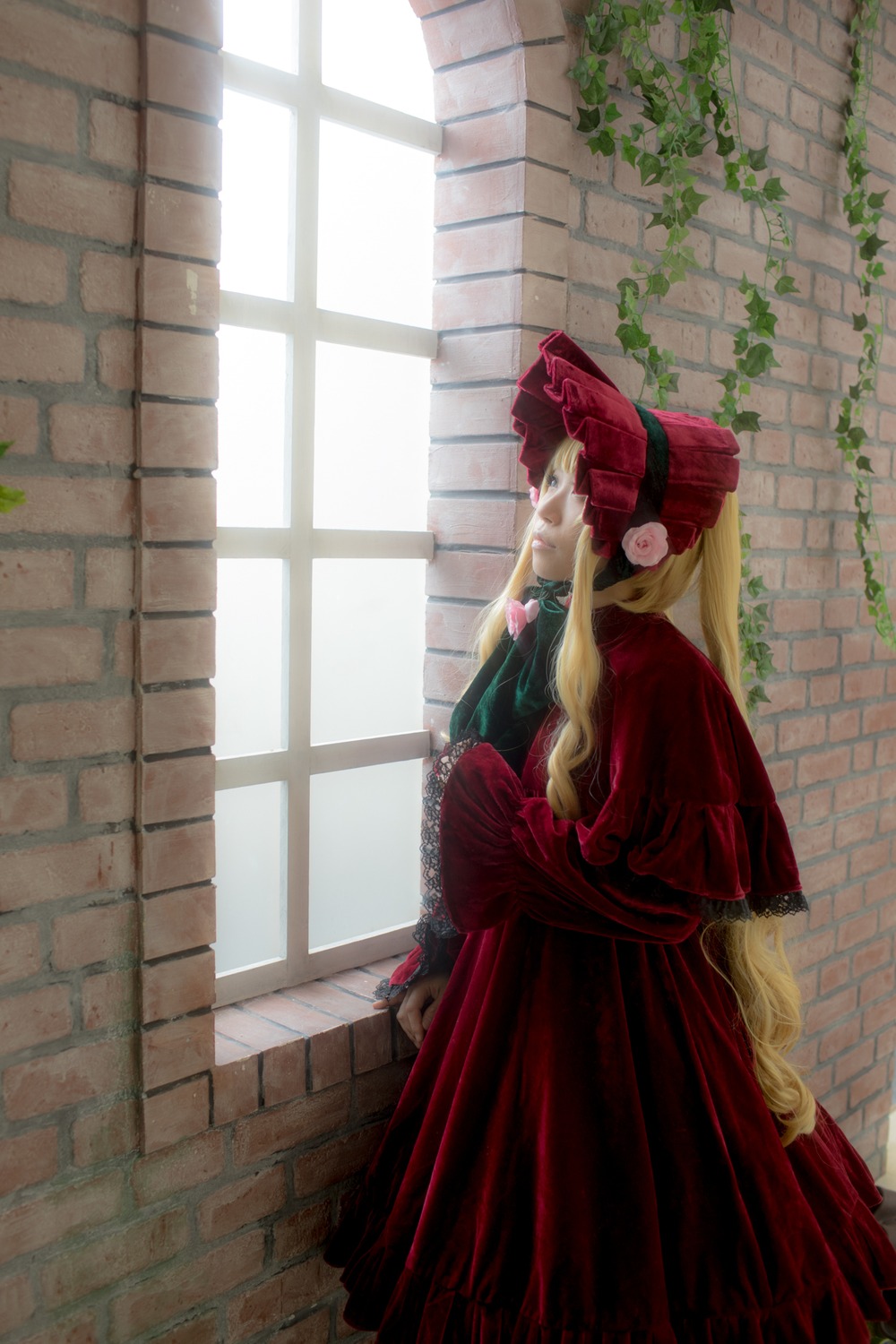 1girl blonde_hair bonnet brick_wall dress lolita_fashion long_hair long_sleeves profile red_dress shinku solo standing tiles very_long_hair wall window