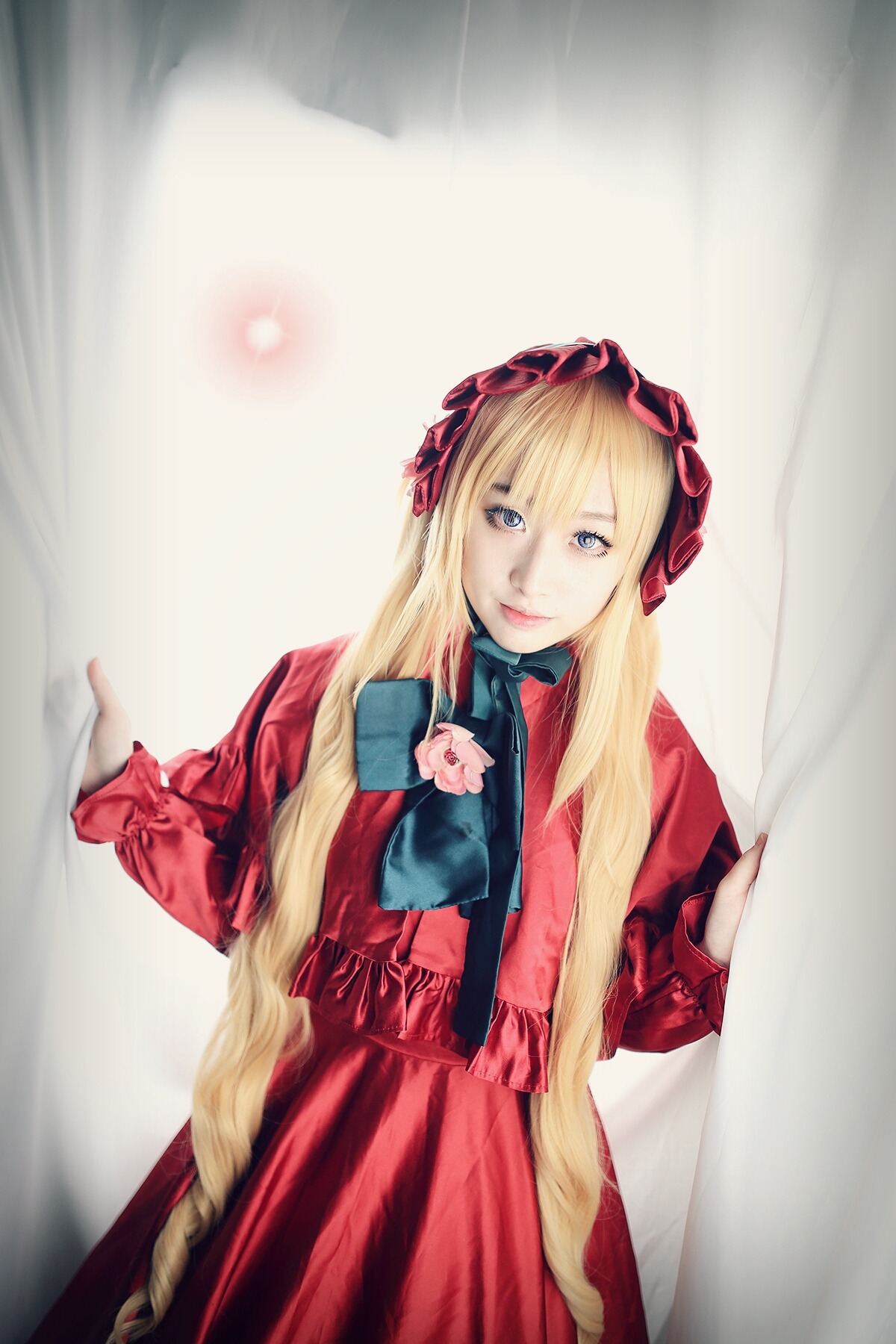 1girl blonde_hair blue_eyes bow bowtie cowboy_shot dress flower hairband long_hair long_sleeves looking_at_viewer red_dress shinku smile solo very_long_hair