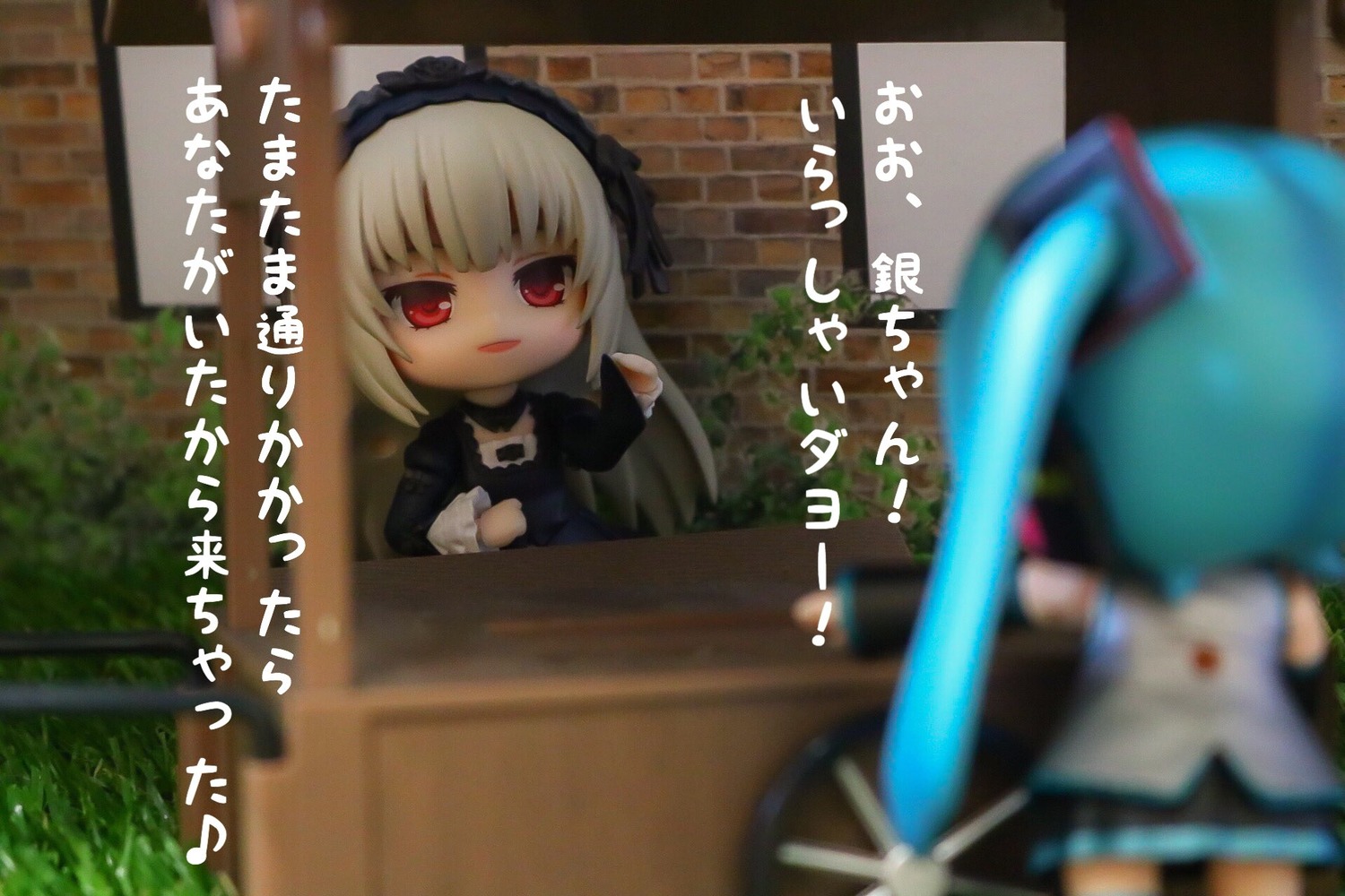 2girls 3d blonde_hair blurry blurry_background blurry_foreground depth_of_field doll dress figure hairband lolita_hairband long_hair motion_blur multiple_girls photo red_eyes sitting solo suigintou