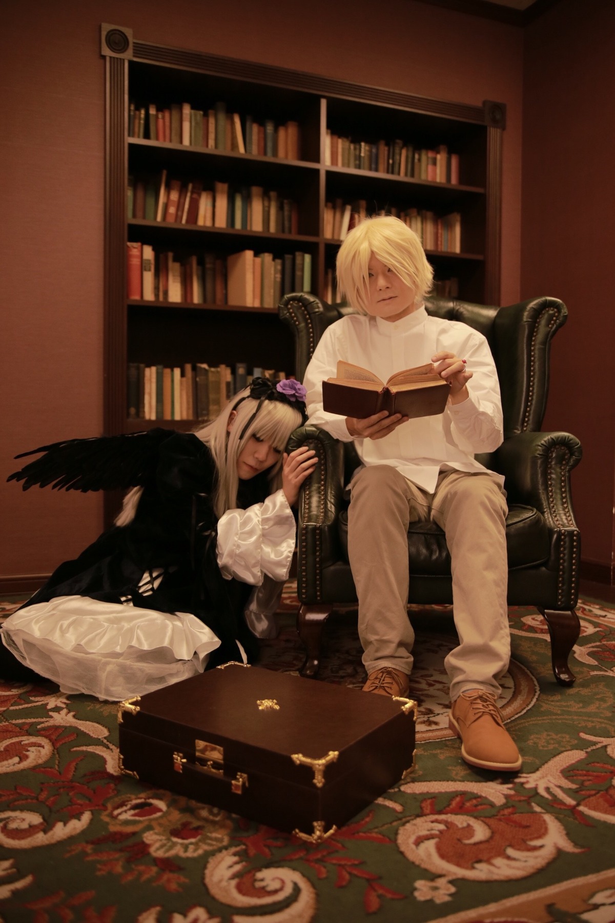 1boy 1girl blonde_hair book bookshelf closed_eyes flower hair_over_one_eye long_hair reading sitting solo suigintou wings
