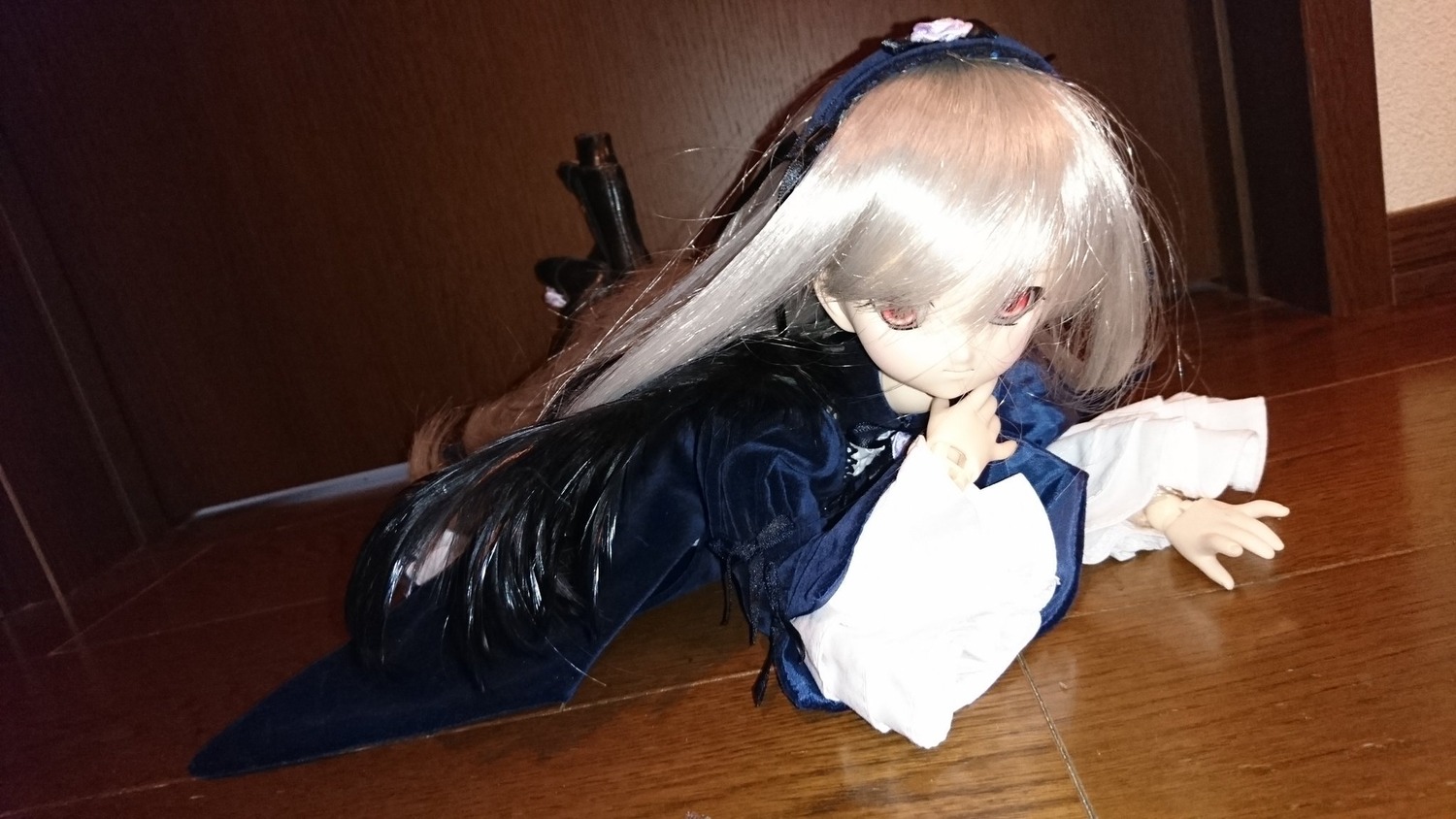 1girl doll dress indoors long_hair long_sleeves red_eyes solo suigintou very_long_hair white_hair