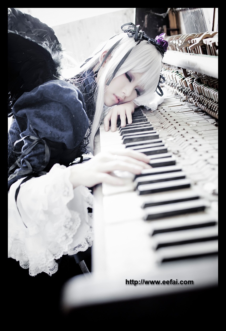 1girl black_border blurry blurry_foreground closed_eyes closed_mouth crown depth_of_field dress feathers frills instrument letterboxed lips long_hair long_sleeves ribbon solo suigintou white_hair wings