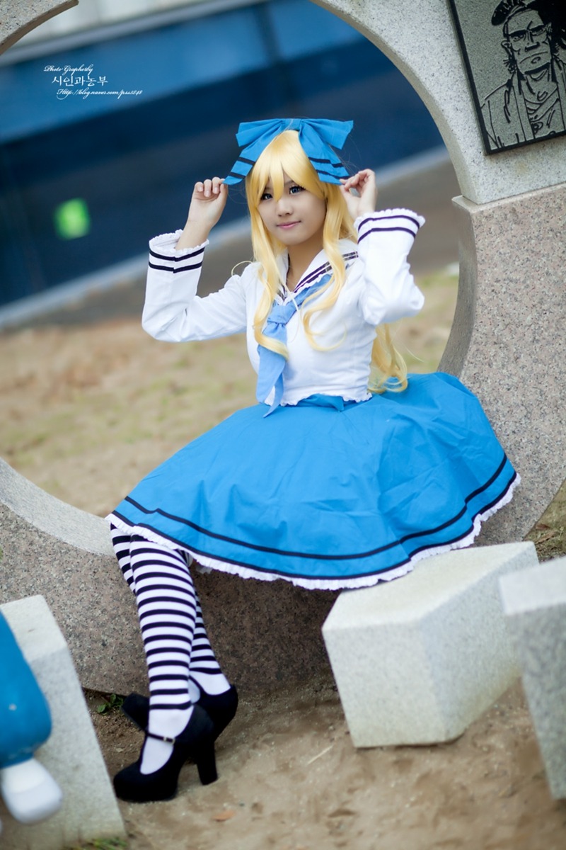 1girl 3d blonde_hair blue_eyes blue_skirt blurry blurry_background blurry_foreground depth_of_field figure high_heels long_hair photo sailor_collar shinku skirt solo
